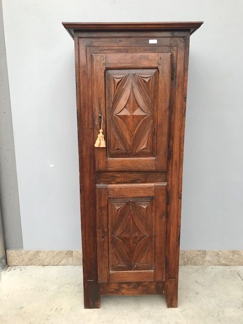 Antique 2-door cabinet made of oak with diamond-carved panels.