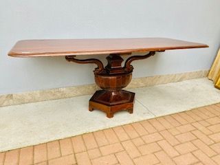Rectangular mahogany Charles X table, central cup-shaped support with dolphin carvings.
