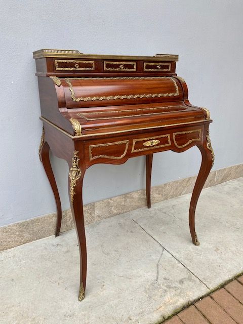 Louis XV mahogany roll-top desk rich in bronze.