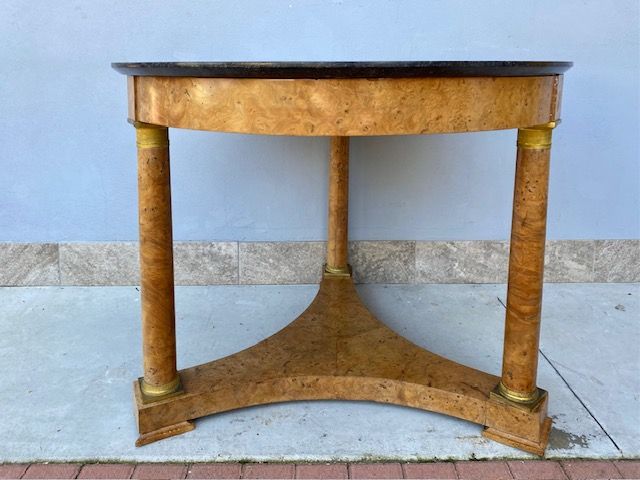 Important Round Empire Table in Tuia Briar has original gilded bronzes and a black marble top.